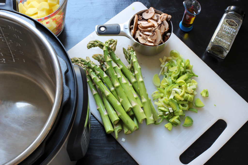 prepping asparagus soup vegetables on cutting board.