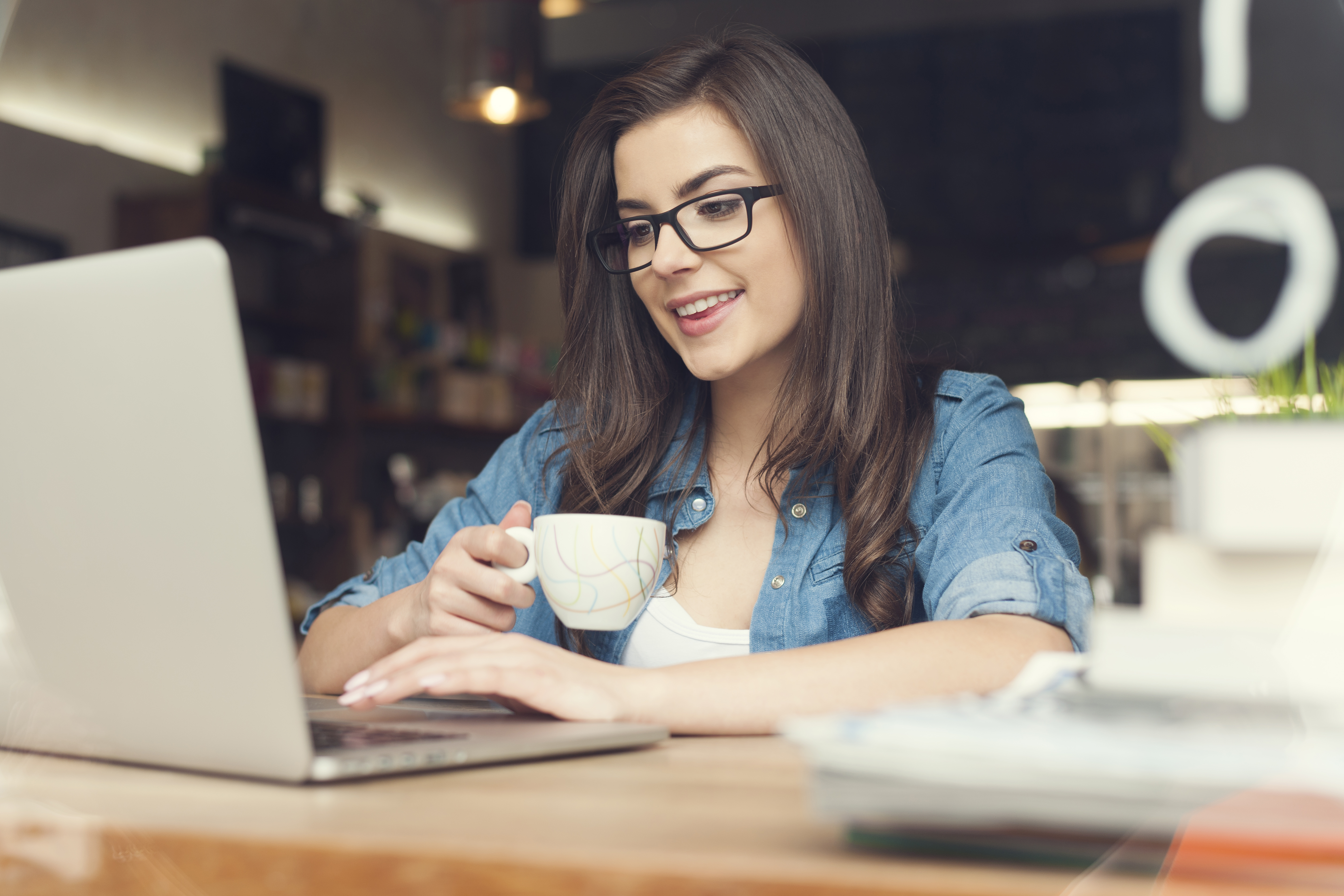 woman at laptop with coffee